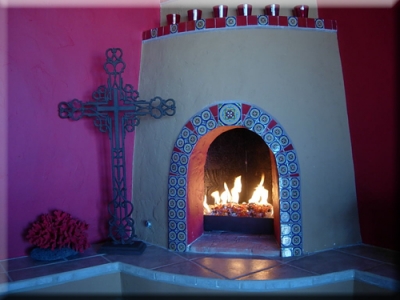 traditional mexican style fireplace with fire glass
